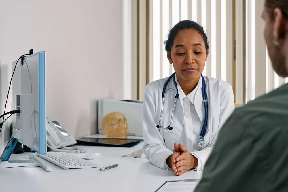 Doctor talking with a patient during a consultation about health coverage