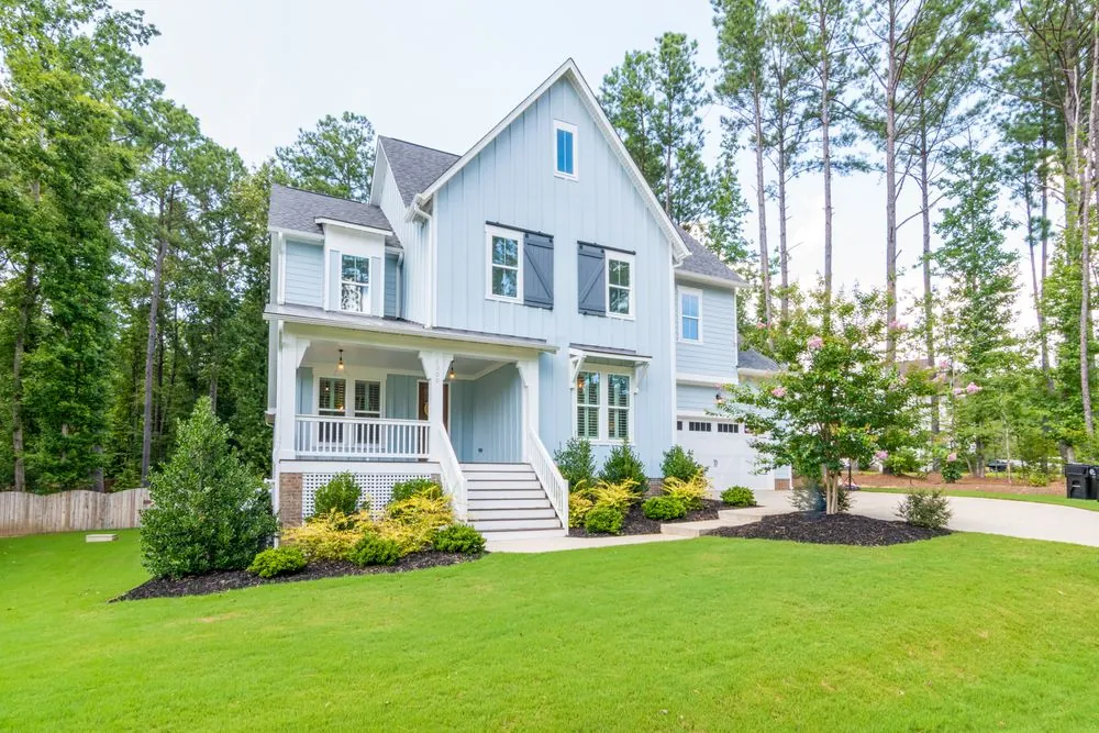 Detached family house with a front porch and lawn, the kind of home a home insurance policy covers